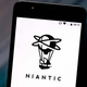 A close up photo of a phone screen shows the Niantic logo.